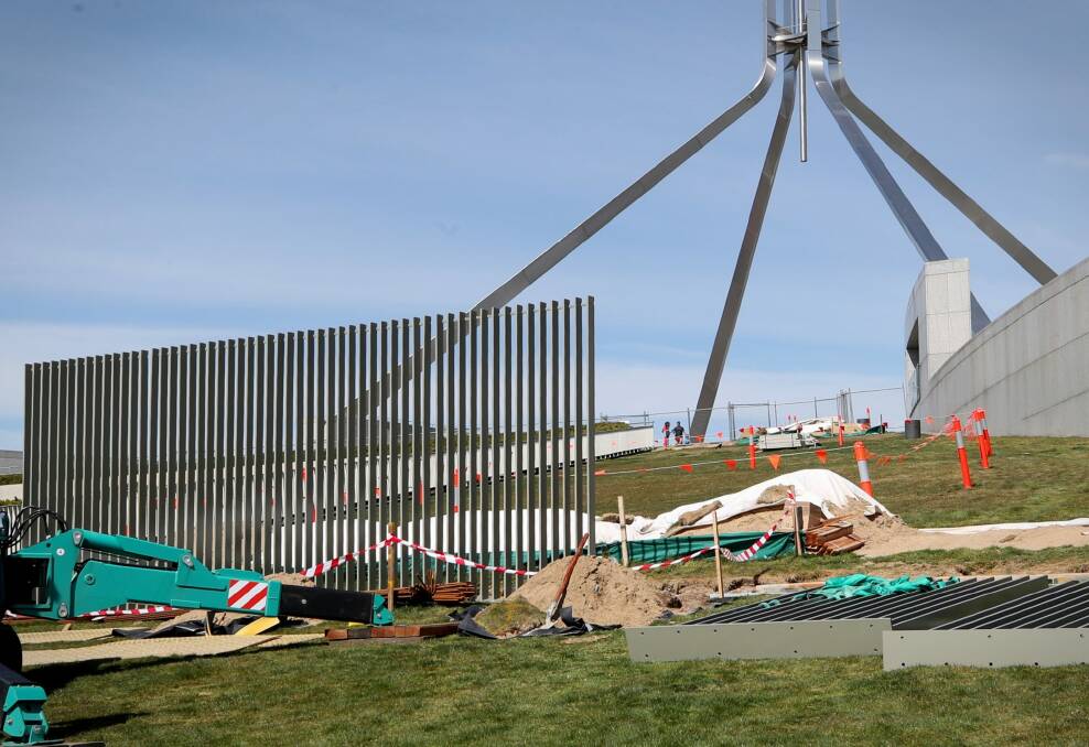 A security fence is installed across the lawns of Parliament House in Canberra on Tuesday. Photo: Andrew Meares