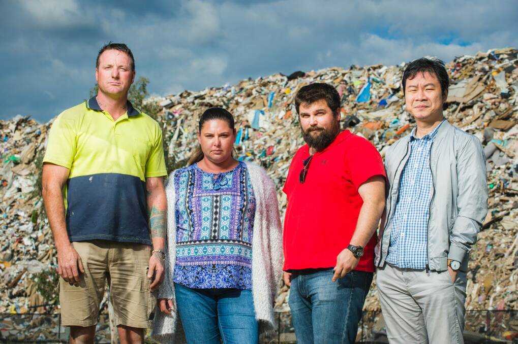 Damian Wade, Linda Galea, Daniel Ciccarone, and Stanley Chin from nearby business IC Formwork are unimpressed with the smelly pile of rubbish growing next to their workplace in Hume.  Photo: Sitthixay Ditthavong