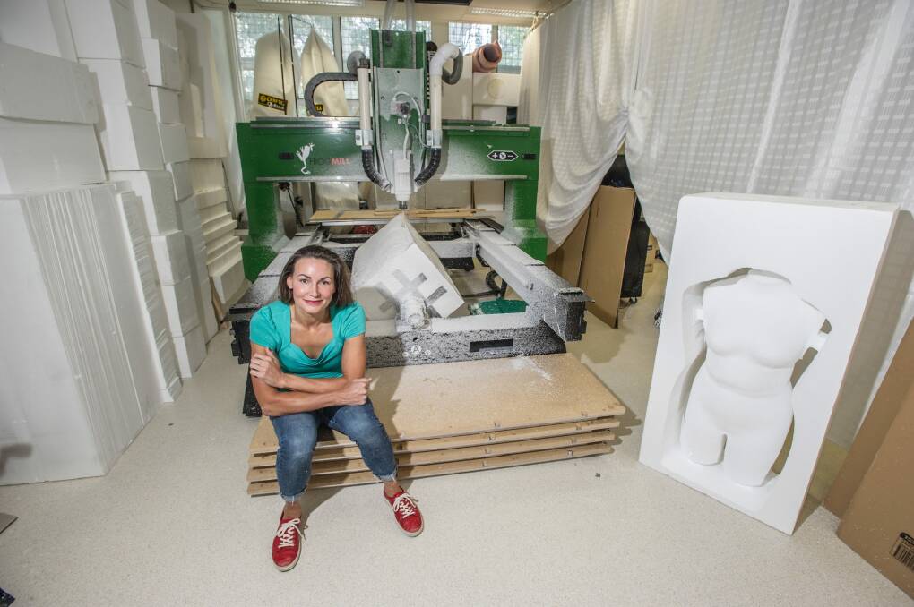 Entrepreneur Hollie Bell with her CNC machine and one of her torsos. Photo: karleen minney
