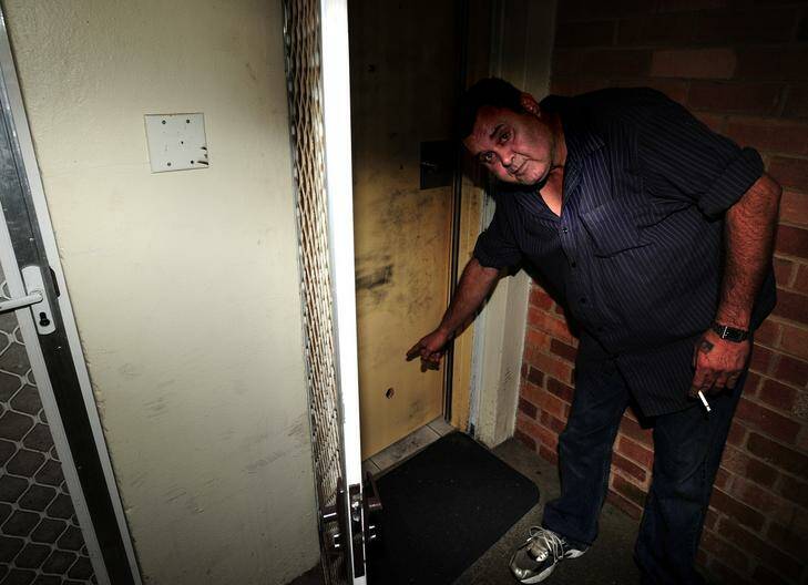 Close call ... Albert Ferguson shows where his front door was shot at early yesterday. Photo: karleen minney