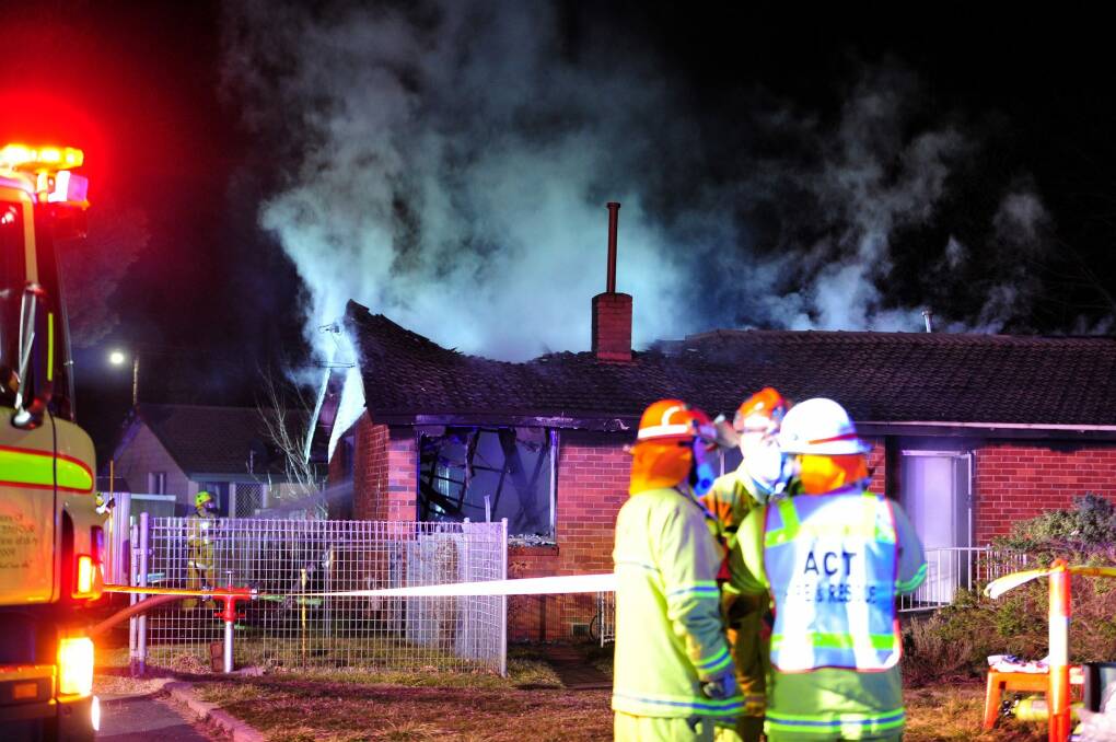 ACT Fire and Rescue workers at the scene of a house fire earlier this year Photo: Melissa Adams