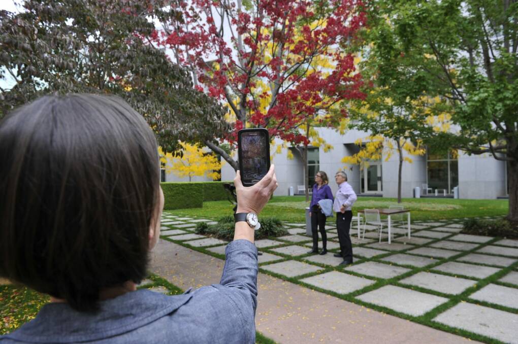 Autumn-lovers admire the trees in a Parliament House courtyard during one of the Colours in the Courtyards tours. Photo: Supplied