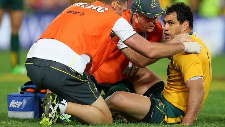 Dazed: George Smith is treated after a knock to the head in Saturday's clash. Photo: Getty Images