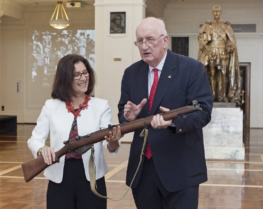 Former deputy prime minister Tim Fischer hands over his Enfield 303 rifle to Museum of Australian Democracy director Daryl Karp at Old Parliament House. Photo: Supplied