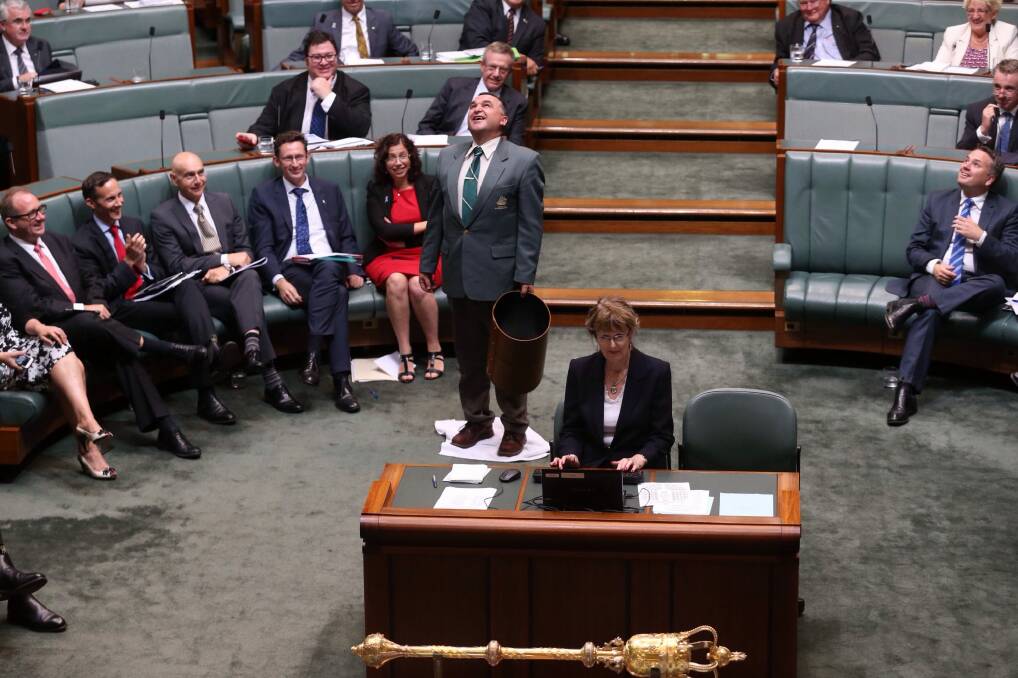 An attendant mops up a leak from the roof during question time.  Photo: Andrew Meares