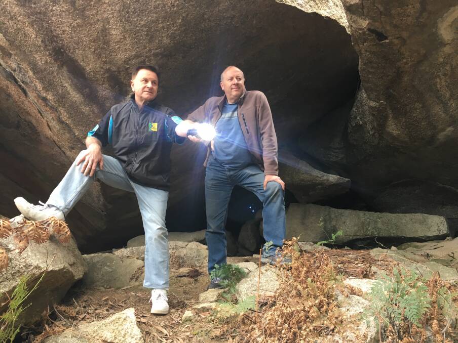 Geocachers Greg Shaw and Thomas Schulze emerge from the ‘secret’ cave in Pierces Creek Forest. Photo: Tim the Yowie Man