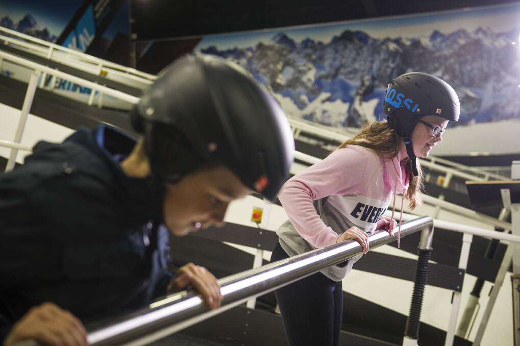 Riley and Jessica learn to snow plough at the ski bar. 'Make your skis like a big piece of pizza!' instructor Paolo Bellini yells. Photo: Dion Georgopoulos