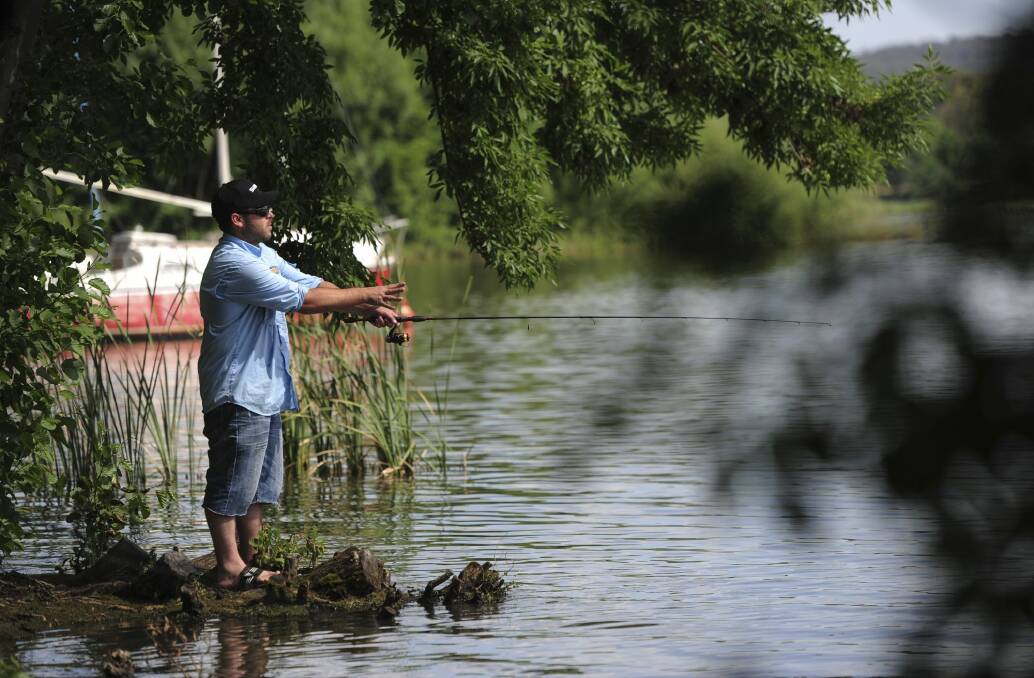 Adam Samios fishing in Lake Burly Griffin. Photo: Graham Tidy