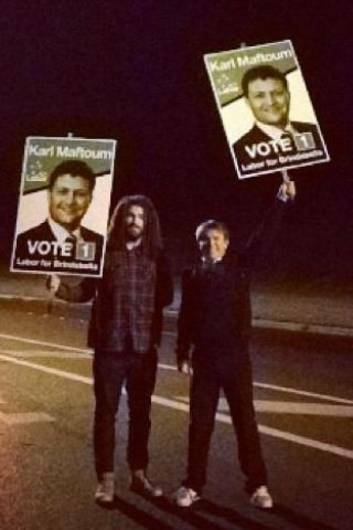 Dean Goulder (right), an ALP supporter, has posted this picture on a social networking site of himself  and a friend waving uprooted posters for Brindabella candidate Karl Maftoum.