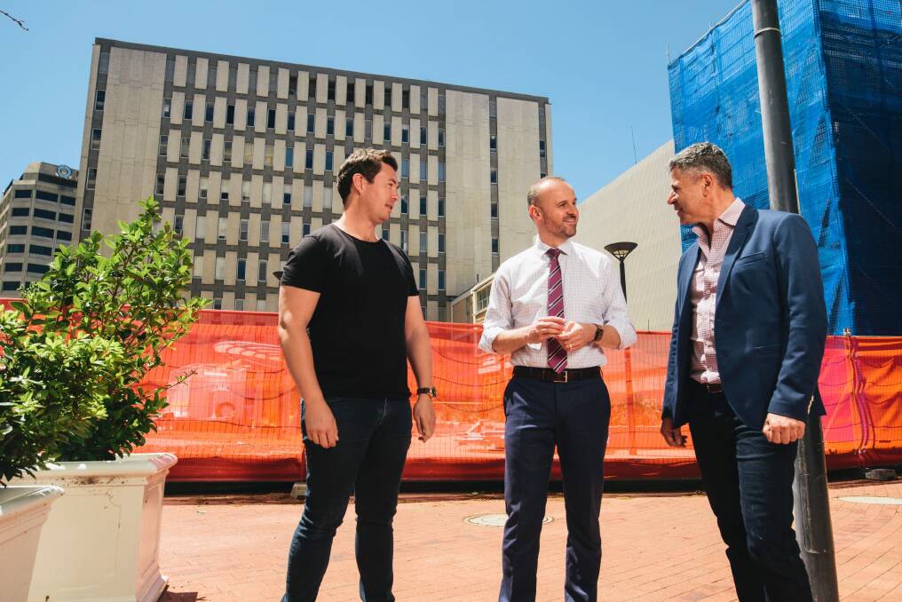 Crafted's Matt James, left, and Peter Sarris, right, discuss the new development with Chief Minister Andrew Barr onsite in London Circuit. Photo: Rohan Thomson