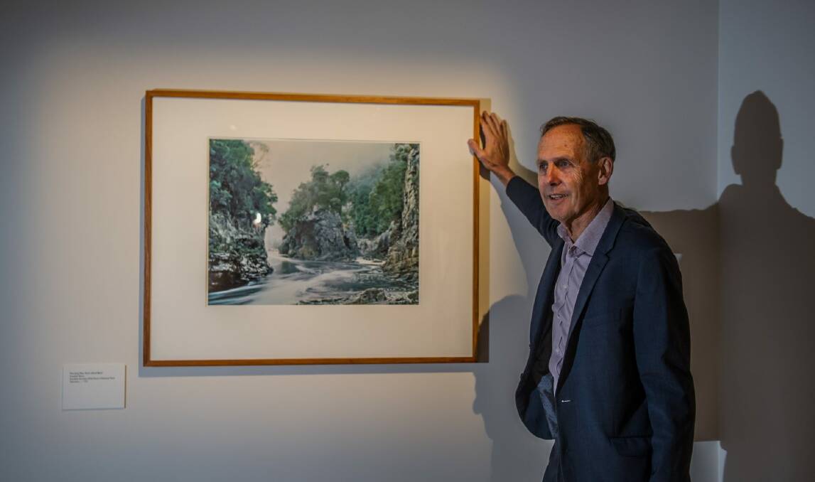 Former Greens leader Bob Brown poses with the Peter Dombrovskis photograph that was instrumental in saving the Franklin River.  Photo: Karleen Minney