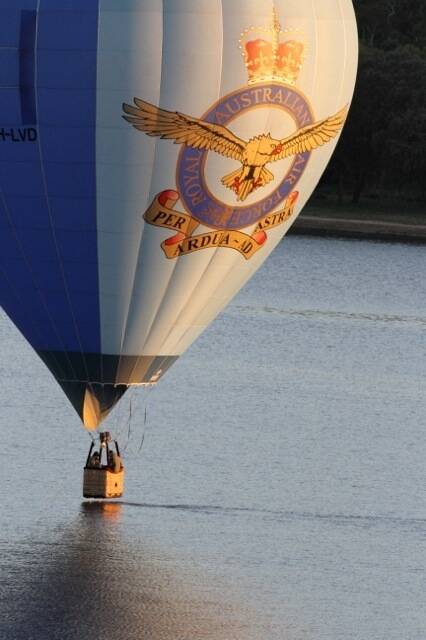 RAAF hot-air balloon skimmed the water then rose, very slowly about 6.30am Wednesday morning. Photo's taken lake-side at Kingston Photo: Frank Jackson