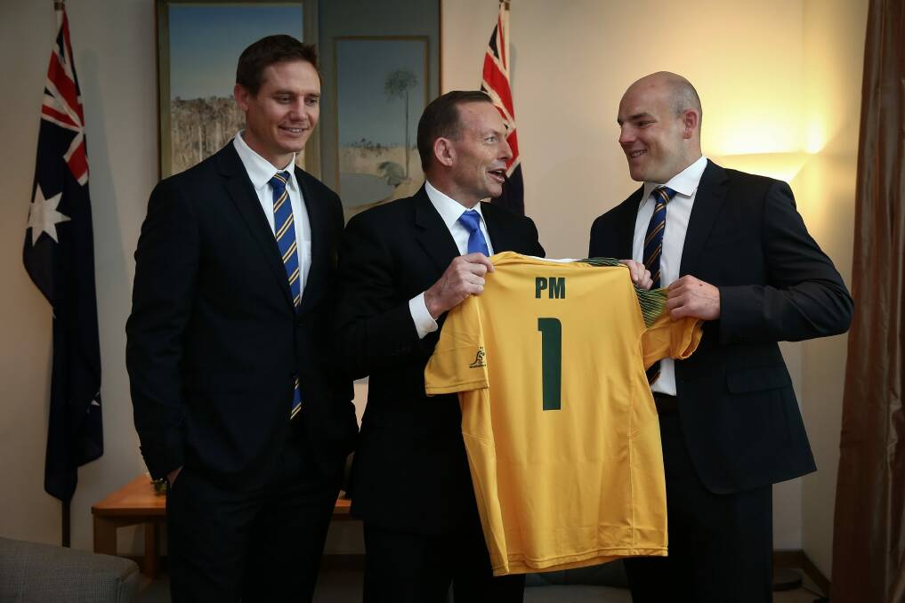 One for the pool room: Former Prime Minister Tony Abbott meets Wallabies assistant coach Stephen Larkham and Wallabies captain Stephen Moore in August. Photo: Alex Ellinghausen