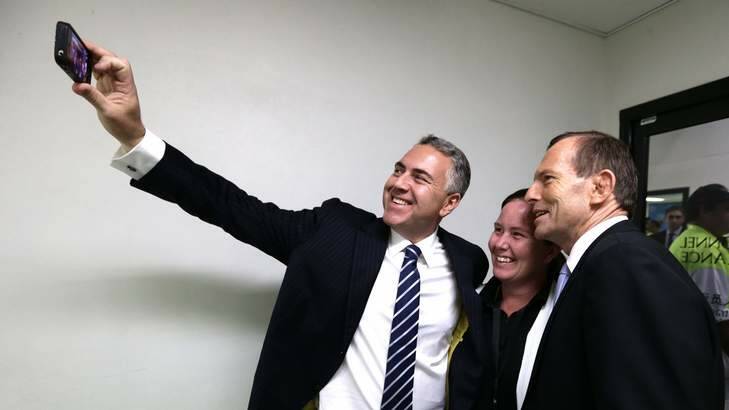 Treasurer Joe Hockey, Carmel Busby and Prime Minister Tony Abbott take a "selfie". Photo: Alex Ellinghausen