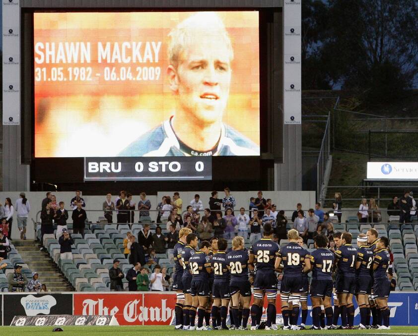 Brumbies players gather to applaud former team mate Shawn Mackay who recently passed away, before the round nine Super 14 match between the Brumbies and the Stormers at Canberra Stadium on April 11, 2009.