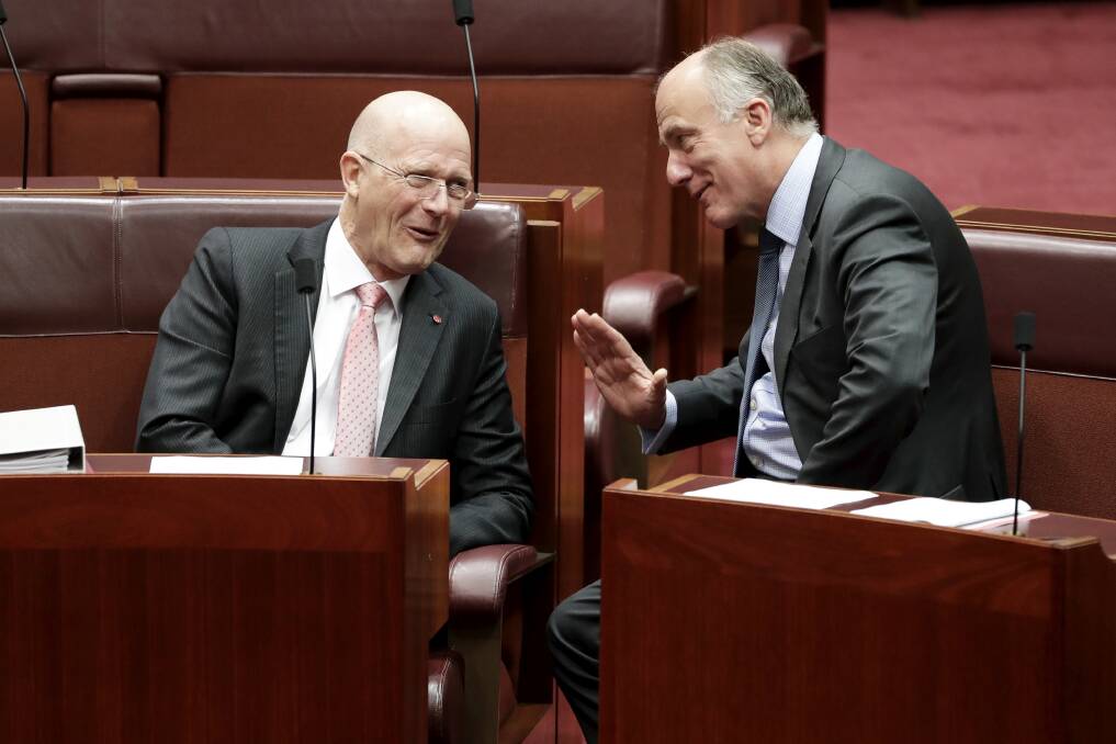 Senators David Leyonhjelm and Eric Abetz in discussion during debate in the Senate at Parliament House in Canberra on  Wednesday. Photo: Alex Ellinghausen