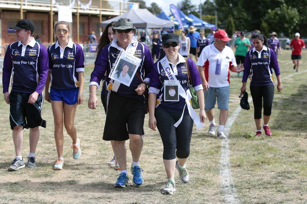 Glen Jones, centre left, of Jerrabomberra, and daughter Hayley Jones, centre right, walk in memory of Noreen Jones. Photo: Jeffrey Chan