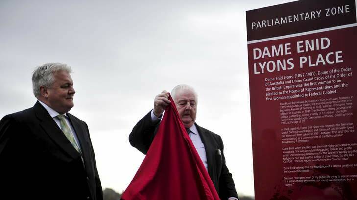 Peter Lyons and his son Peter Lyons unveil an interpretative panel honouring Dame Enid Lyons located near the National Library of Australia. Photo: Jay Cronan