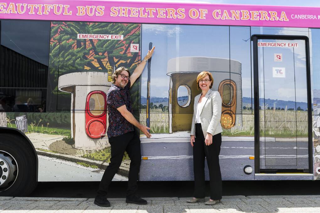 Canberra artist Trevor Dickinson and Transport Minister Meegan Fitzharris with the new bus wrapped in Dickinson's bus-stop artwork. Photo: Dion Georgopoulos