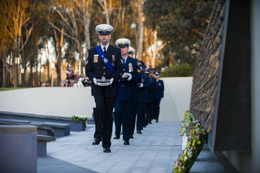 Officers at the solemn ceremony at the National Police Memorial in Kings Park. Photo: Rohan Thomson