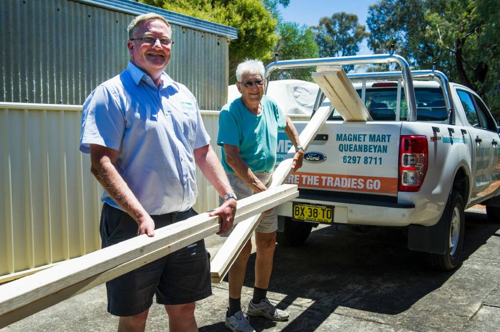 Toymaker John Fillery (right)l had a huge response to his call for timber including from Magnet Mart Queanbeyan's Andrew Busch who made a special delivery  on Thursday. Photo: Elesa Kurtz