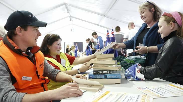 Lifeline director of commercial operations, Matt Heffernan with volunteer Mariel Lapus help price books for Kate Wells from Spence and Jarrah Ransome from Gundagai at the Lifeline Book Fair. Photo: Jeffrey Chan