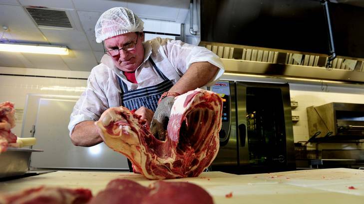 Gary Whetton works on a joint of lamb yesterday at CIT. He also discussed the various cuts and cooking techniques. Photo: Melissa Adams