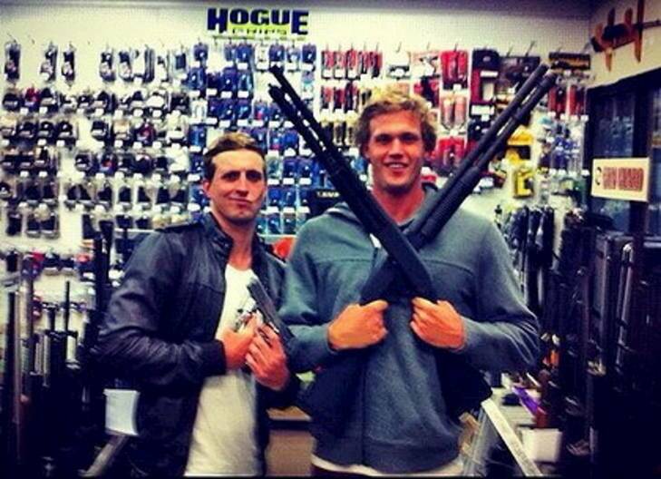 Australian swimmer Nick D'Arcy and teammate Kenrick Monk posing with guns in a picture on D'Arcy's Facebook page. The duo will finalise their preparations with the rest of the Australian Olympic swimming team in Canberra from Friday.    ipad-art-wide-darcy_guns-420x0.jpg