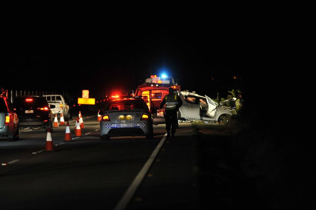Police attend a fatal car crash on the Federal Highway on Sunday. Photo: Jay Cronan