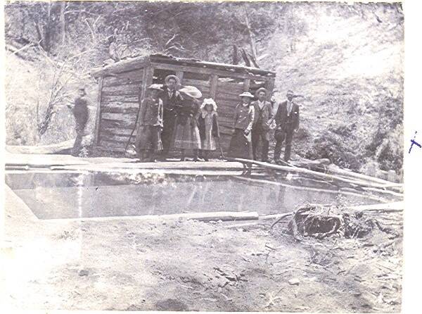 Yarrangobilly's thermal pool in circa 1898,  showing a slab sided change room and the pool lined with timber. Photo: Tumut Historical Society and Yarrangobilly Caves
