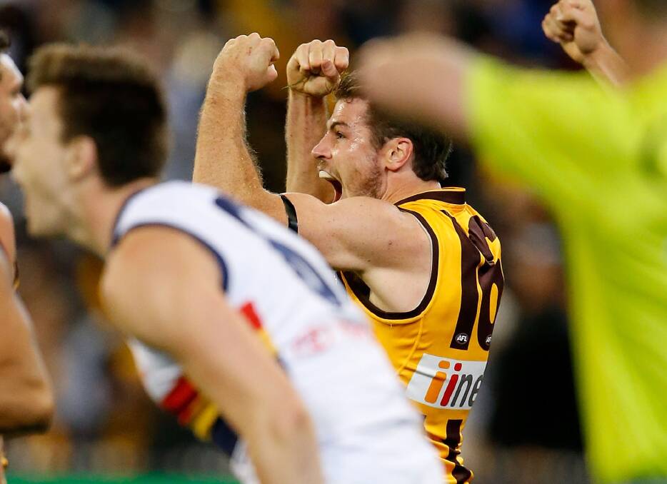Winners are grinners: Isaac Smith celebrates on the siren. Photo: AFL Media/Getty Images