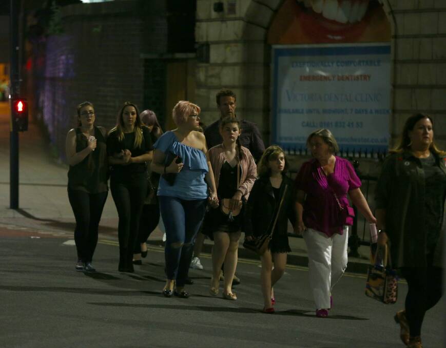 Members of the public depart Manchester Arena following a suicide bombing after Ariana Grande had performed. Photo: Dave Thompson