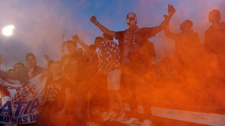 Canberra FC fans let off flares early in the game against Olympic in 2011. Heather Reid says capital Football will adopt a firm stance on misbehaving supporters. Photo: Gary Schafer