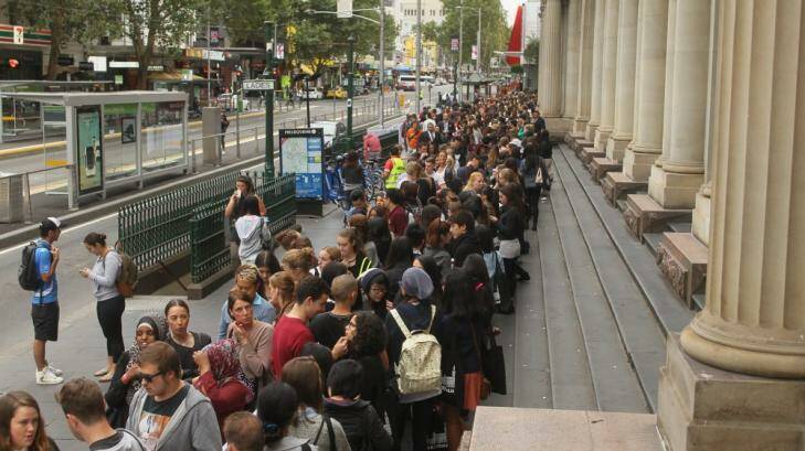 The queue snakes down Elizabeth Street prior to the official opening of H&M in Melbourne. Photo: Ken Irwin