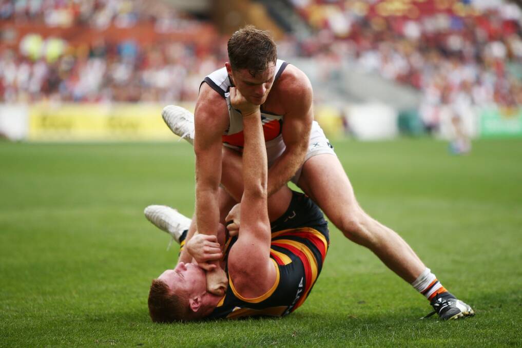 Close-fought: Tom Lynch of the Crows and Heath Shaw of the Giants get to grips. Photo: Morne de Klerk