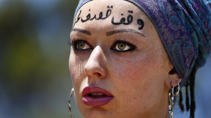 Renee Jan from Gilmore with "stop bombing Gaza" written in Arabic on her forehead during a Rally for Palestine rights. Photo: Jeffrey Chan