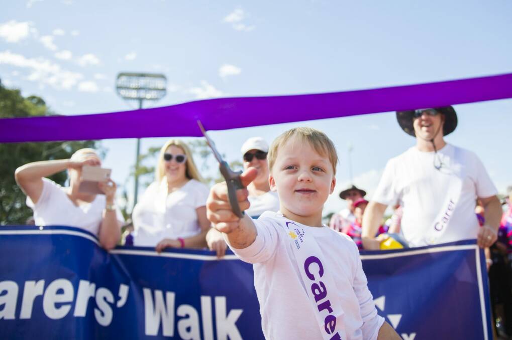 Ben Woodhams, 5, who lost his brother earlier in the year, cuts the ribbon to start the Relay for Life.  Photo: Rohan Thomson