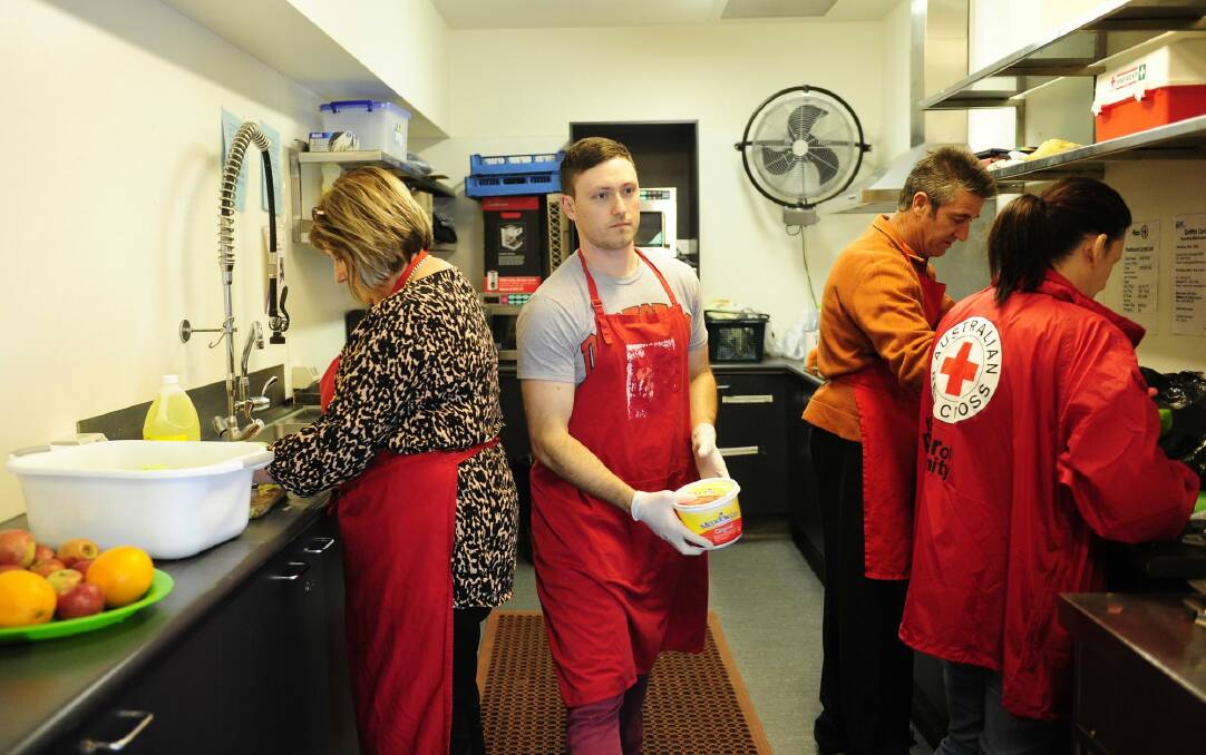 The Red Cross which prepares meals for the people of Canberra in need at the Griffith Centre in Civic. From left, volunteers,  Leanne Spiteri, Jonathan Coe, Raymond Spiteri and liaison worker Tracey Crowther  prepare the food. Photo: Melissa Adams