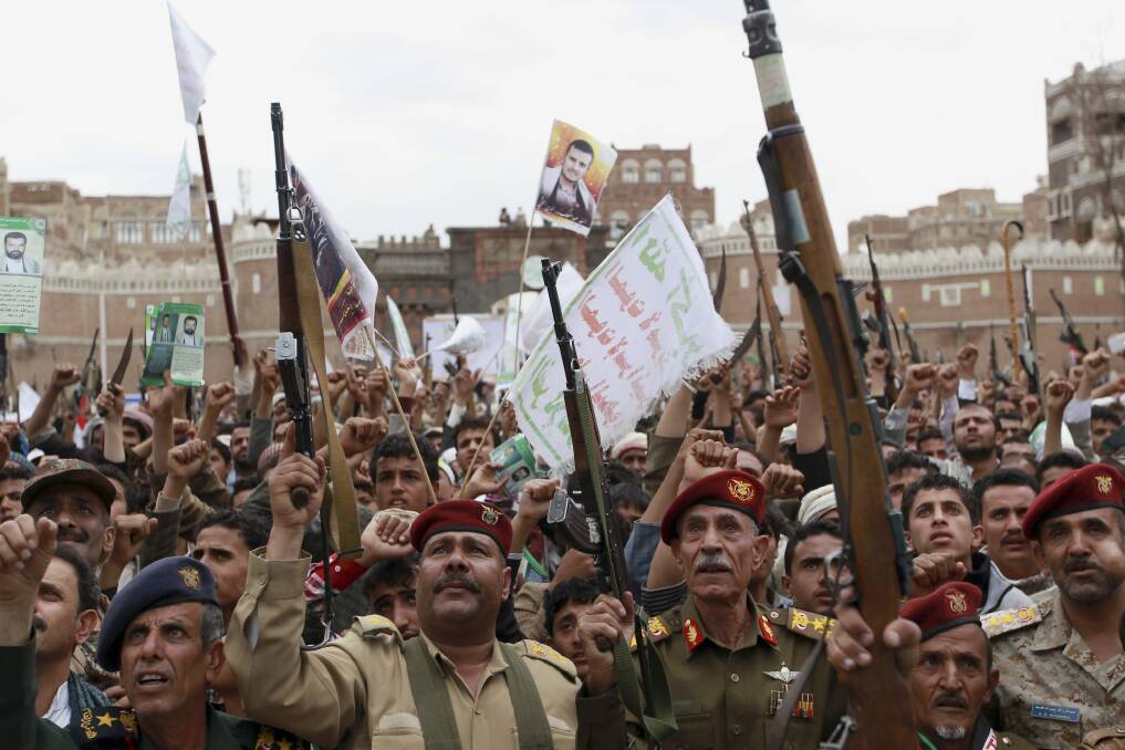 Houthi rebels hold up their weapons to protest against Saudi-led air strikes during a rally in Sana'a last week. Photo: AP