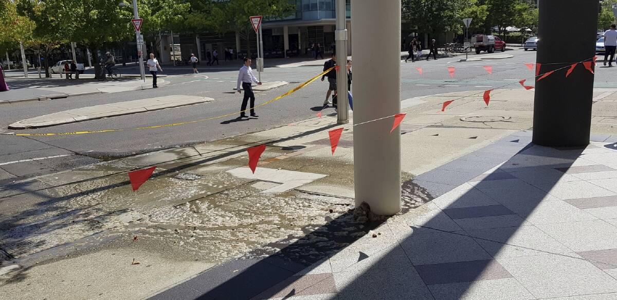 Sewage is seen flowing from a building's pier on Moore Street in Canberra city. Photo: Graeme Taylor