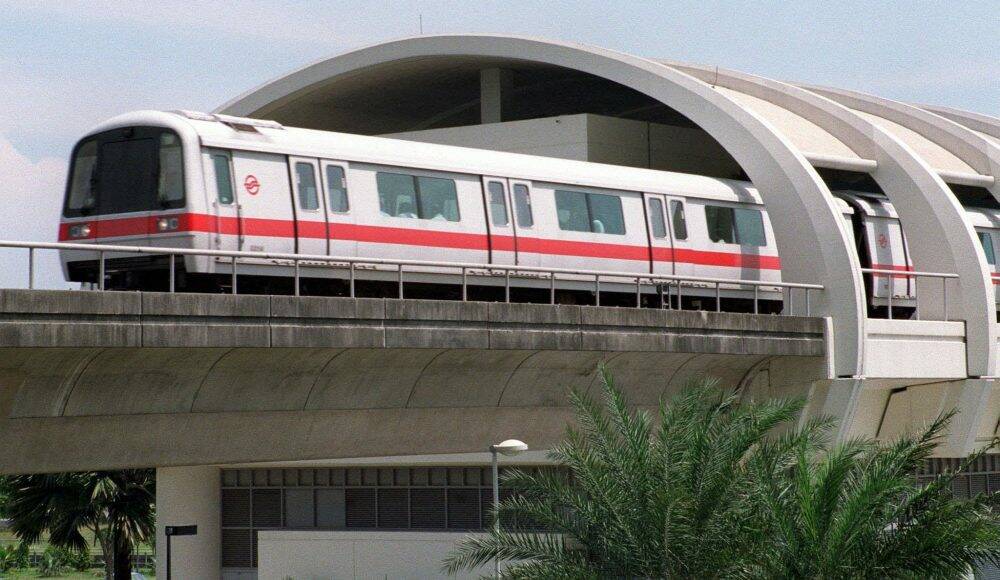 A Singapore Mass Rapid Transit (SMRT) train leaves a station.