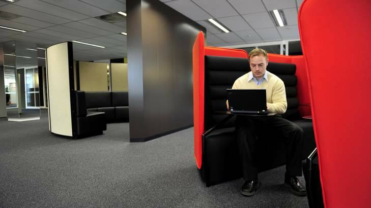 PricewaterhouseCoopers employee David Campbell with the new agility-based (shared-desk) workspace, home to about 200 staff. Photo: Jay Cronan