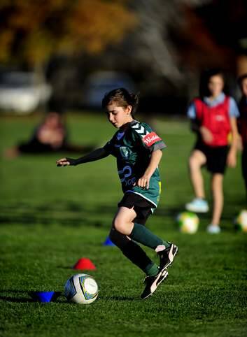 The Vision Australia soccer ball that makes a noise when kicked helps Claire Falls, 10, while playing soccer due to her eye condition Strabismus, which effects her depth perception. Photo: Melissa Adams