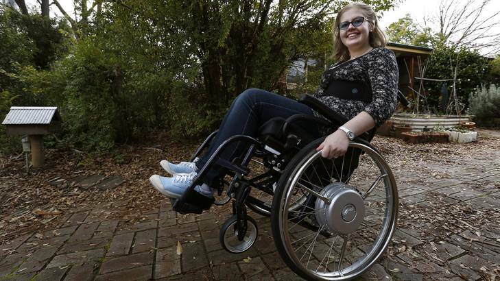 Hannah Coleman does a wheelie in her wheel chair out the front of her Kaleen Home Photo: Jeffrey Chan