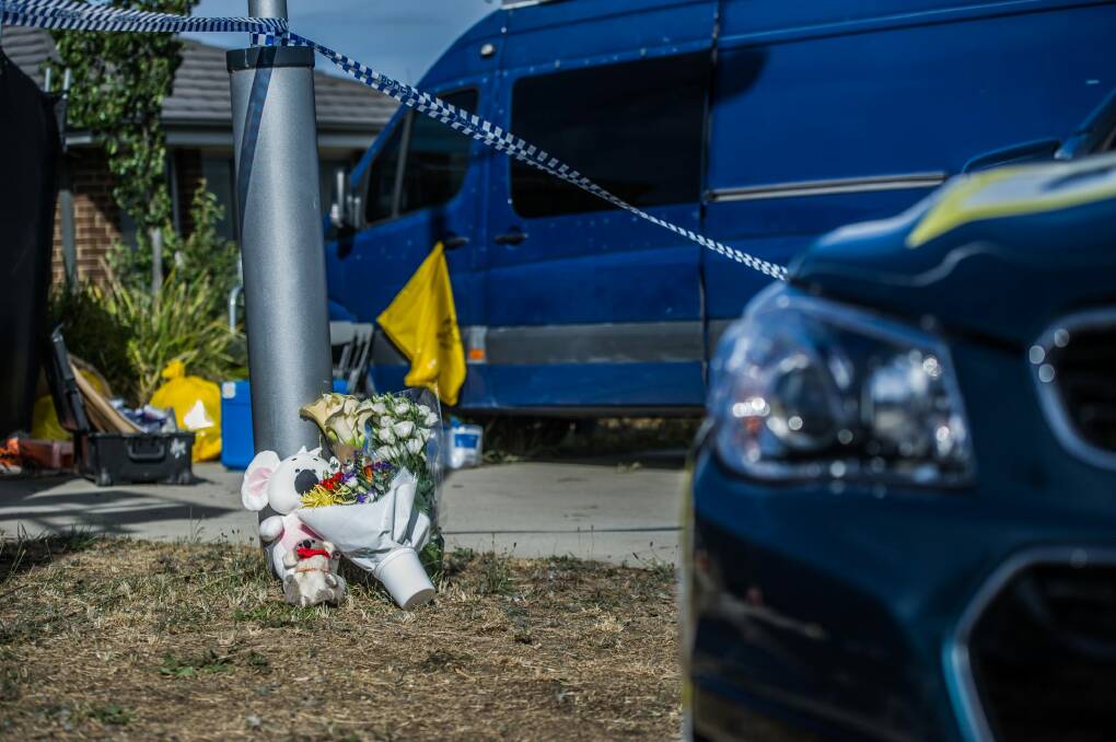 Tributes of soft toys and flowers at the site of the triple death and house fire in Bonner.  Photo: karleen minney