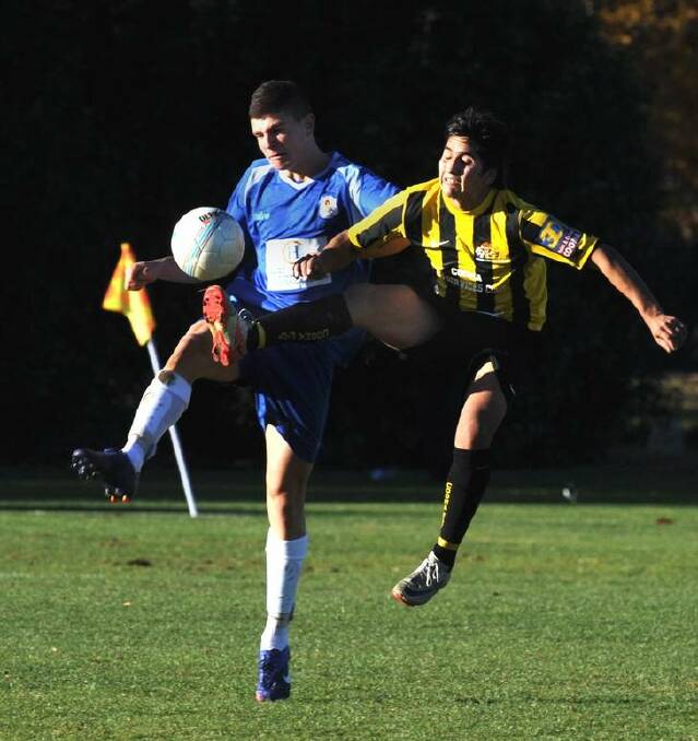 Cooma Tigers goal scorer Gustavo Roldan, right, in action against Canberra Olympic player Nick Bobolas at O'Connor Enclosed Oval. Photo: Richard Briggs