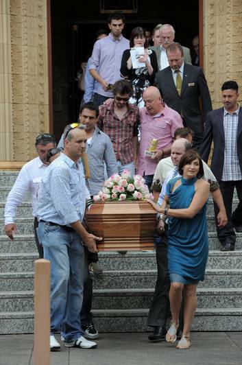 The funeral of Rikki Colosimo at St Christopher's Cathedral, Manuka. Rikki's brother, Ben Colosimo, left and his sister Bobbie Murphy, right, were the front pall bearers as they emerged from the church. Photo: Graham Tidy