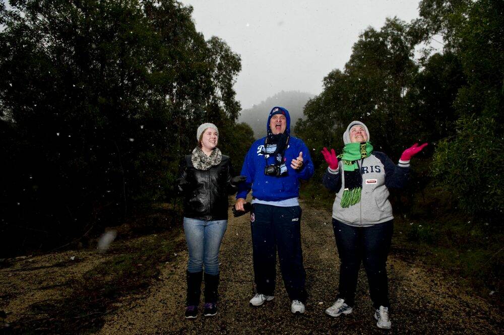 Enjoying the snow near Corin Forest  (l-r) Amy, Craig and Fiona Gilmore of Isabella Plains. Photo: Jay Cronan