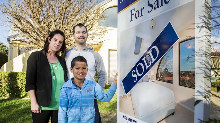 First home buyers Ashley and Terry Lock with their 8y/o son Roman Quarmby outside their new home. Photo: Rohan Thomson