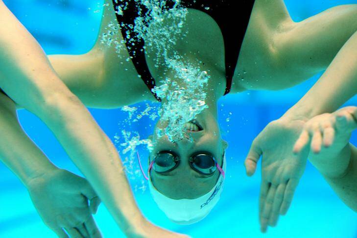 26 April 2012 SPORT Canberra Times photograph by GRAHAM TIDY Story by Lee Gaskin. Members of the Australian Women's Olympic Relay Squad at the AIS Pool. A Squad member plays up to the camera underwater. Photo: Graham Tidy GGT